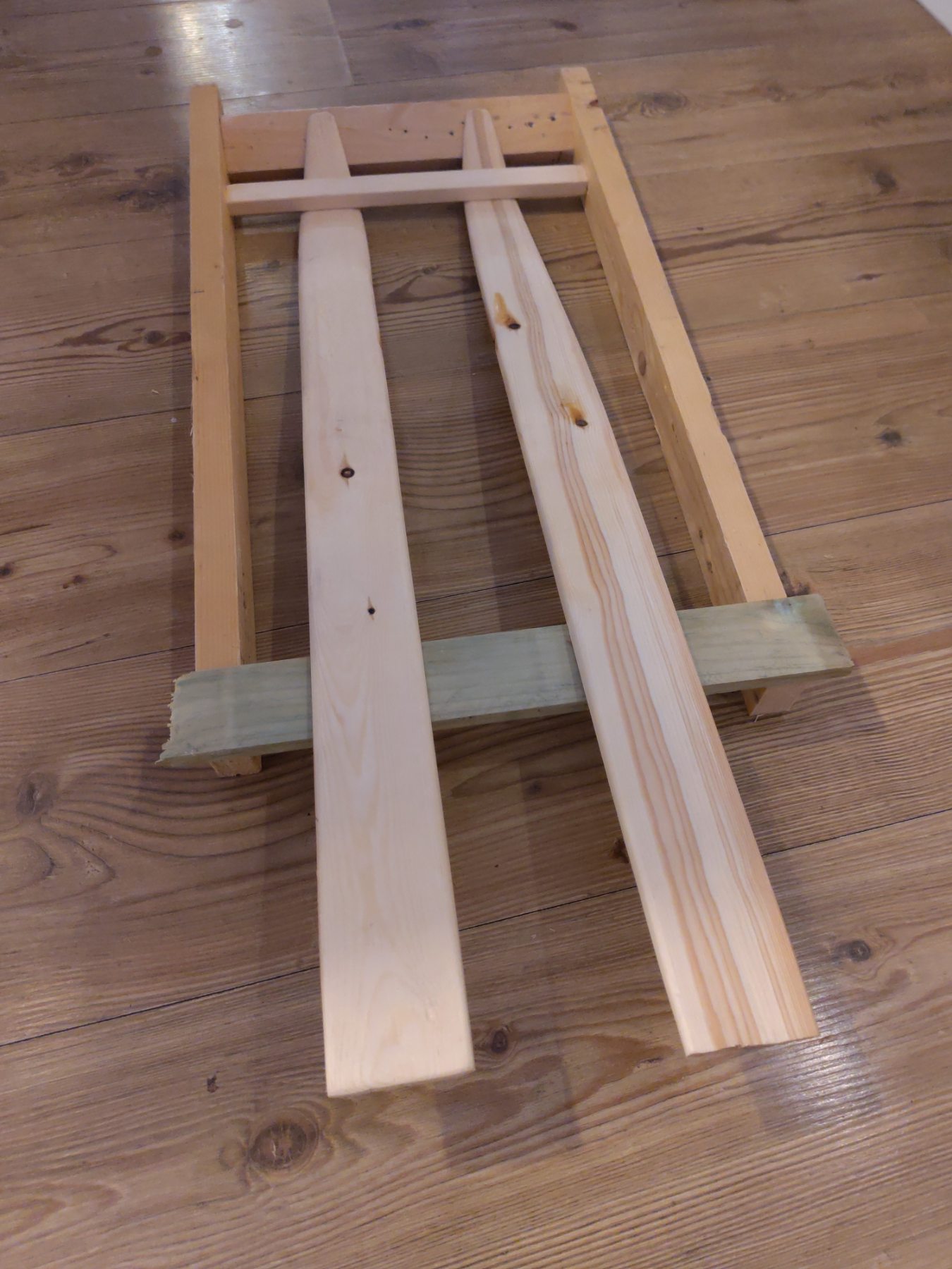 The softened skis are put in a frame.