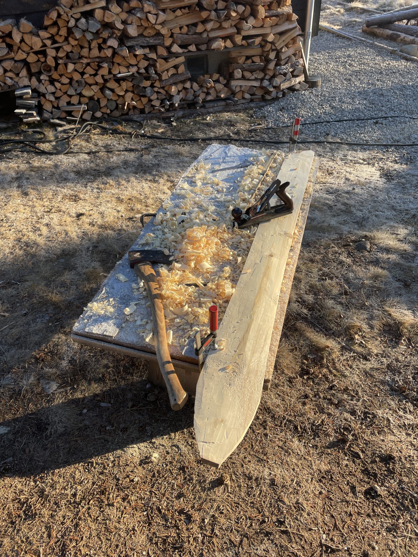 Shaping the wood with an ax and a plane.